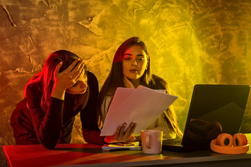 Business woman working on a laptop, stressful situation.