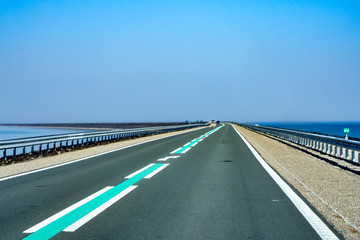 Fototapeta premium Dam between Enkhuizen-Lelystad in the Netherlands. On the west side of the dike is the Markermeer and on the east is the IJsselmeer.