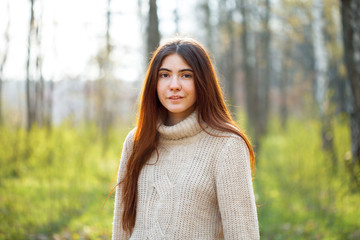 Young woman walking in the bearch grove