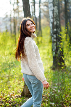 Young woman walking in the bearch grove