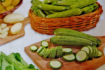 sliced vegetables on a wooden board on a white background