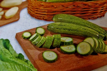 sliced vegetables on a wooden board on a white background