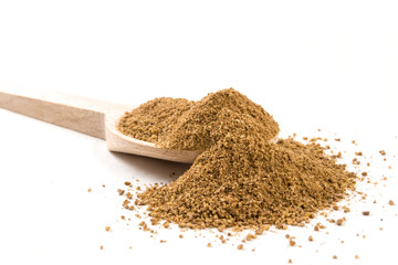 Ground or milled Caraway on wooden spoon on white background