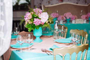 Beautiful bright bouquet of peony on the wedding table in vase