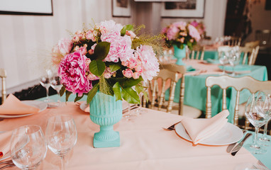Beautiful bright bouquet of peony on the wedding table in vase