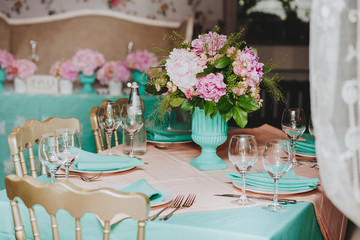 Beautiful bright bouquet of peony on the wedding table in vase