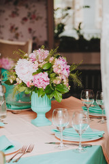 Beautiful bright bouquet of peony on the wedding table in vase
