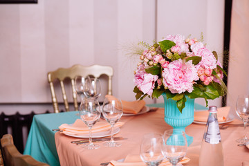 Beautiful bright bouquet of peony on the wedding table in vase