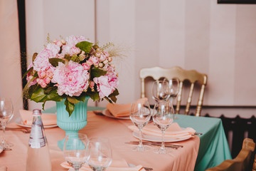 Beautiful bright bouquet of peony on the wedding table in vase