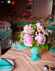 Beautiful bright bouquet of peony on the wedding table in vase