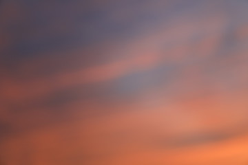 Dramatic sunset sky background with fiery clouds, yellow, orange and pink colour, nature background. Blurred background