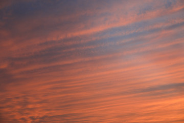 Dramatic sunset sky background with fiery clouds, yellow, orange and pink colour, nature background. Beautiful skies