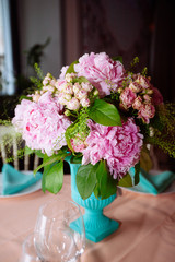 Beautiful bright bouquet of peony on the wedding table in vase