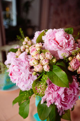 Beautiful bright bouquet of peony on the wedding table in vase