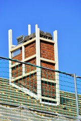 New roofing with chimney under blue sky