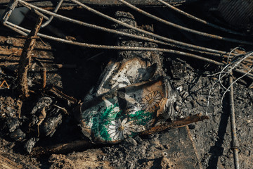 charred pages of a children's book on the ashes of a wooden house