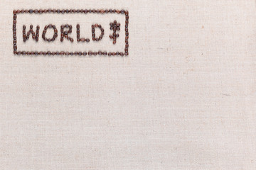 World sign made from coffee beans on linea texture aligned top left.