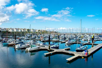 Fotobehang Yachts  and motorboats docked at marina in Bangor. Sailboat Harbor against blue sky © Maciej