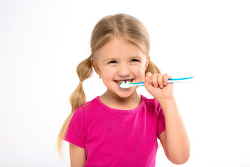 Happy little girl standing with toothbrush isolated on white.little child brush his teeth.Cute...