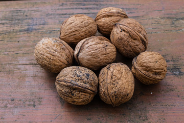 unopened walnuts, with wooden bottom and green trees