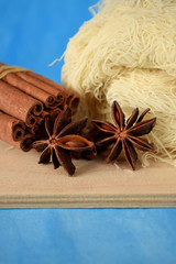 Anise stars, cinnamon sticks and kataifi dough on the wooden board against the blue background