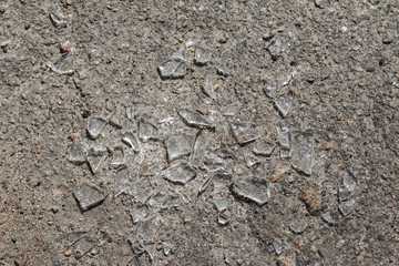 broken glass left on the asphalt pavement after the commission of a road accident.
