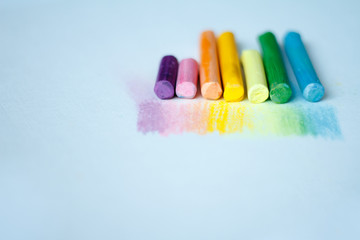 Close up view of the colorful chalk pastels on the white background