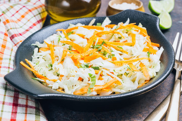 Fresh coleslaw salad in black plate