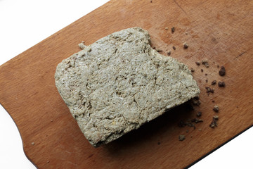 piece of sunflower seed Halva dessert on a wooden cutting board, view from above. dense, sweet confections made in the Middle East, Central Asia and the Indian subcontinent.