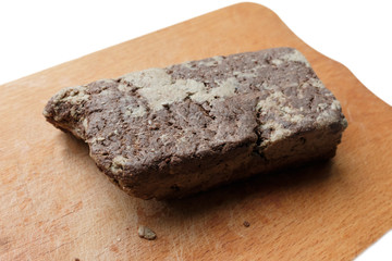 close-up of seed butter halva with cocoa on the wooden cutting board. Halva is any of various dense, sweet confections made in the Middle East, Central Asia and the Indian subcontinent..