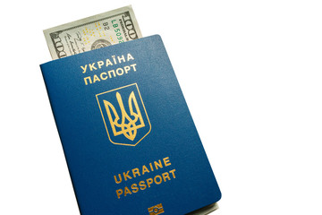 Close-up of Ukrainian International biometric passport with American banknotes inside. Travel concept, isolated on the white background.
