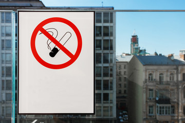 no smoking sign on the white sticker, city buildings in the background.