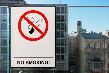 no smoking sign on the glass. photo of no smoking sticker on restaurant window, city buildings...