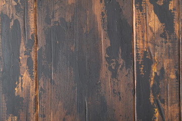 The old wooden surface background, scuffed boards with black paint stains.