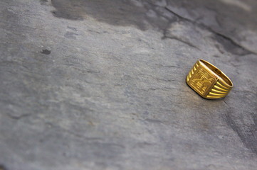 Close up of a golden seal ring with copy space