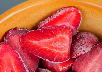 Frozen strawberries in a ceramic bowl