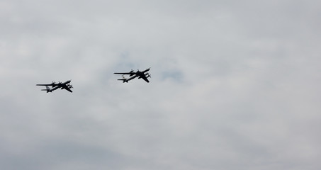 Airplanes flying in cloudy weather sky 