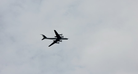 Fototapeta na wymiar Air force aircraft flying on cloudy sky background 