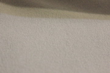Abstract rough fabric texture and empty background of beige color with shades 