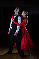 Beautiful young dancers in ballroom isolated on black background