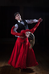Beautiful young dancers in ballroom isolated on black background