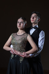 Beautiful young dancers in ballroom isolated on black background