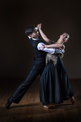 Fototapeta na wymiar Beautiful young dancers in ballroom isolated on black background