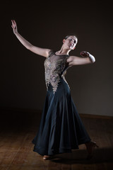 Beautiful dancer girl in ballroom isolated on black background