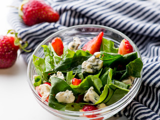bowl of vegan  salad with strawberries and blue cheese