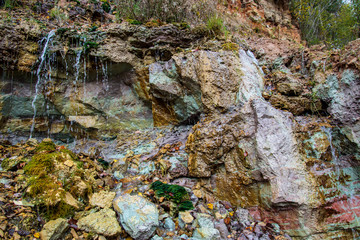 Obraz premium sandstone cliffs with waterfall near river