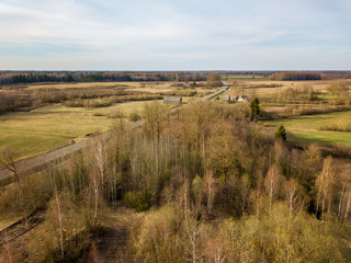 Fototapeta premium aerial view of country roads and small village with houses and lake
