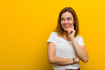 Young natural caucasian woman relaxed thinking about something looking at a copy space.