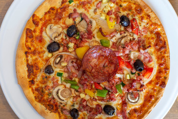 Pizza with salami, mushroom and other ingredients
