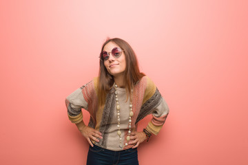 Young hippie woman on pink background scolding someone very angry